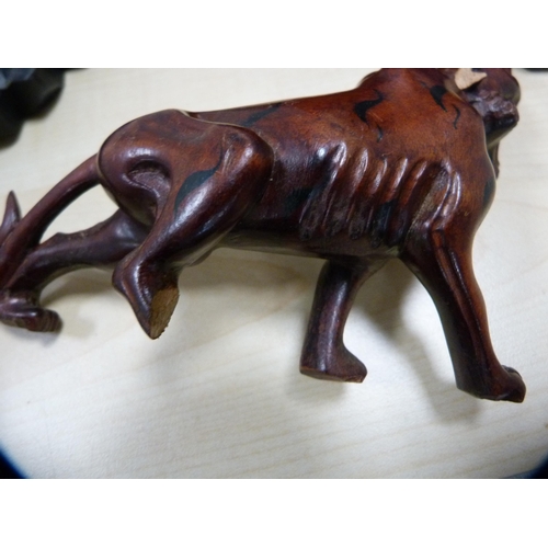 230 - Oriental resin-style figure of a water buffalo and a similar figure of a tiger, both on ebonised sta... 