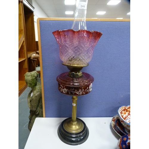 244 - Early 20th century Young oil lamp with brass column, cranberry glass reservoir and later  glass shad... 