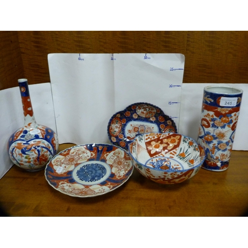 245 - Five pieces of antique Japanese Imari to include a bottle vase, plate, cylindrical vase and bowl.