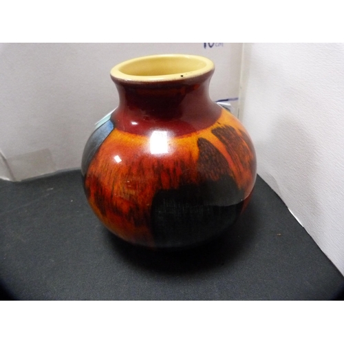 255 - Poole Pottery spill vase and a cylindrical box and cover.  (2)