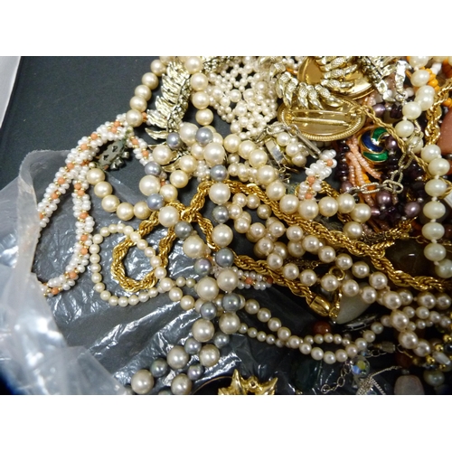 291 - Bag containing a large quantity of costume beads and jewellery.