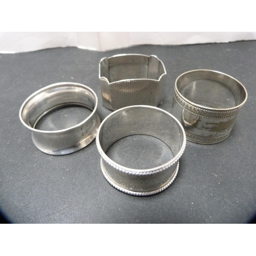 292 - Three silver napkin rings and another, unmarked, 64.4g gross.  (4)