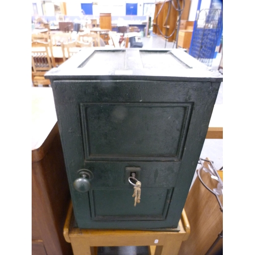 365 - Painted metal safe with key on a trolley base.