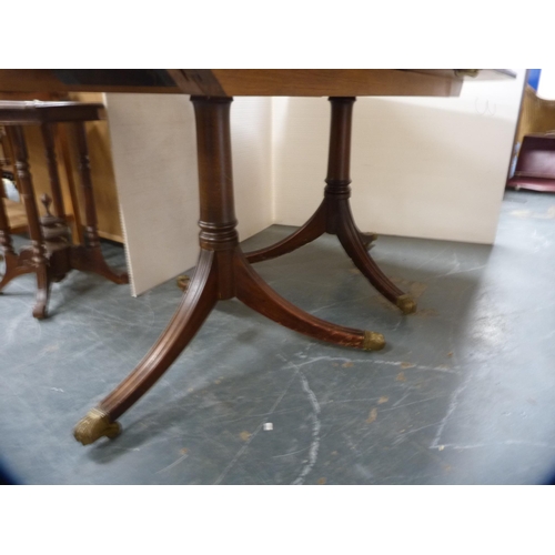 462 - Reproduction twin-pedestal dining table with two additional leaves, on brass paw feet and cappings, ... 