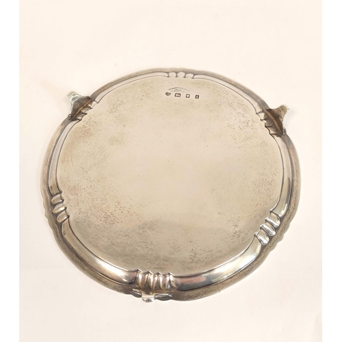 46 - Silver waiter with shaped moulded edge on scroll feet by The Goldsmiths & Silversmiths Co 1934. ... 