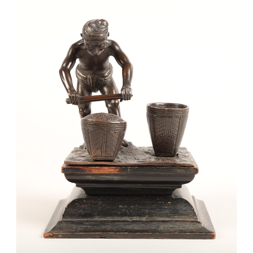 284 - Oriental bronze figure, mounted to a hardwood stand, height 17cm