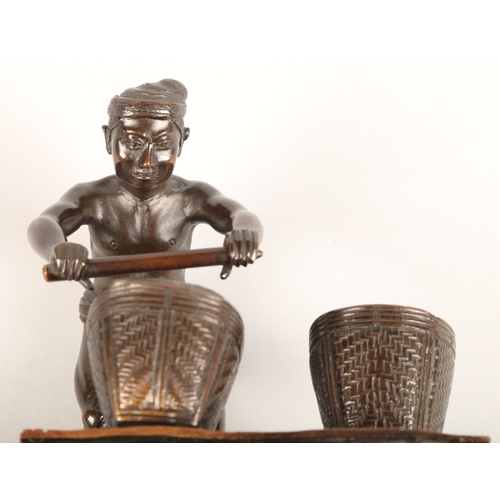 284 - Oriental bronze figure, mounted to a hardwood stand, height 17cm