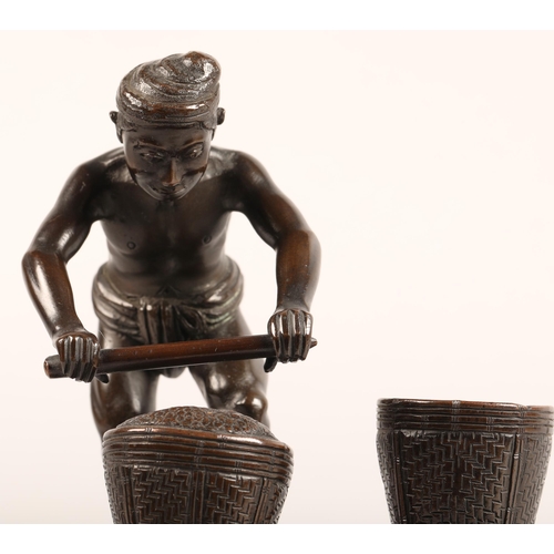 284 - Oriental bronze figure, mounted to a hardwood stand, height 17cm