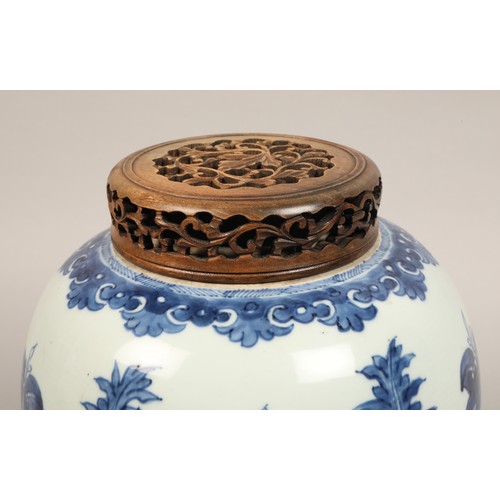 262 - 19th century Chinese blue and white ginger jar, with carved hardwood cover, the jar decorated with a... 