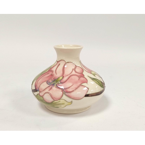 304 - Moorcroft pink hibiscus tube lined vase, of squat size, approximately 11cm high.