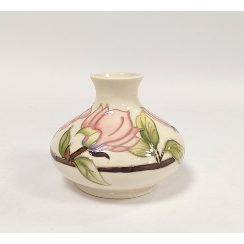 304 - Moorcroft pink hibiscus tube lined vase, of squat size, approximately 11cm high.