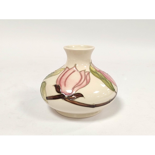 304 - Moorcroft pink hibiscus tube lined vase, of squat size, approximately 11cm high.