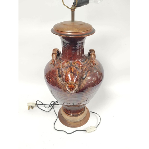 305 - Treacle glazed table lamp of large proportions, the baluster shaped vase with Indian elephant mask a... 