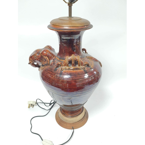 305 - Treacle glazed table lamp of large proportions, the baluster shaped vase with Indian elephant mask a... 