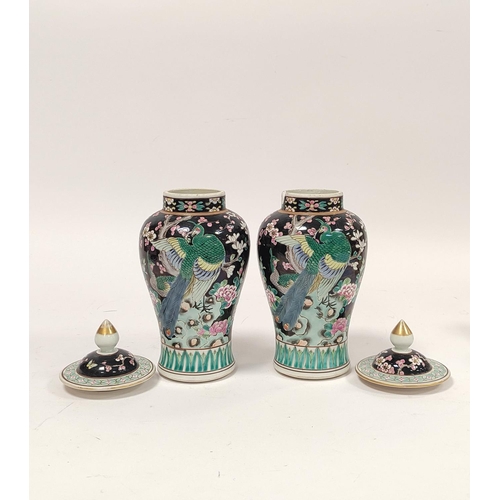 355 - Pair of Chinese famille rose baluster vases with covers, decorated with polychrome birds of paradise... 