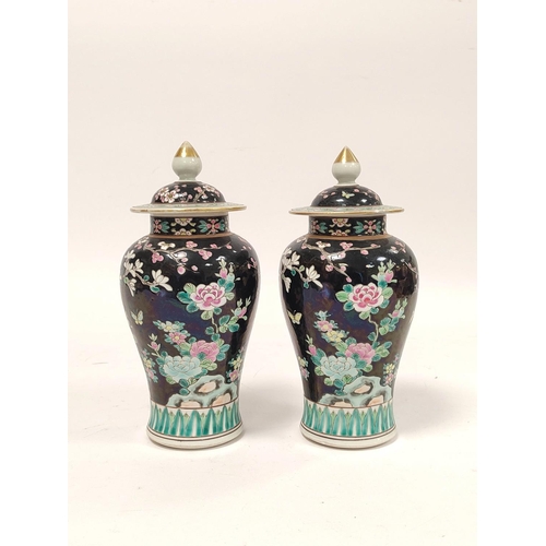 355 - Pair of Chinese famille rose baluster vases with covers, decorated with polychrome birds of paradise... 