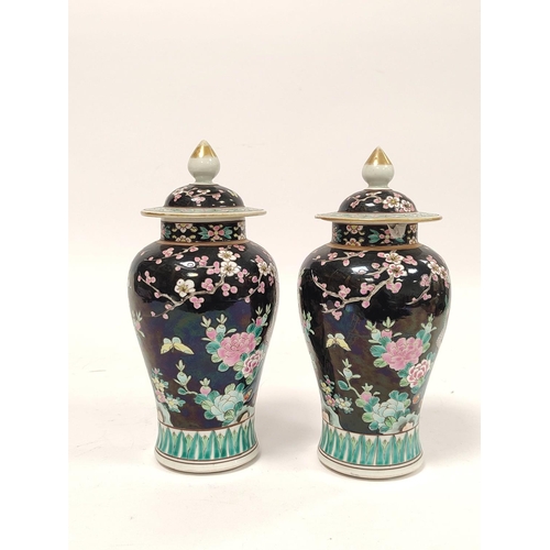 355 - Pair of Chinese famille rose baluster vases with covers, decorated with polychrome birds of paradise... 