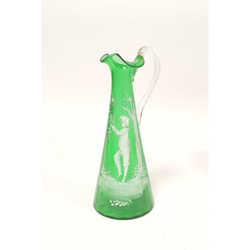 184 - Mary Gregory green glass ewer decorated with white painted image of a boy at a tree, 29cm high.