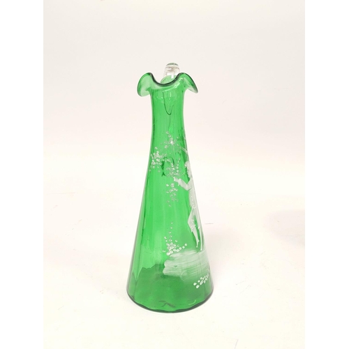 184 - Mary Gregory green glass ewer decorated with white painted image of a boy at a tree, 29cm high.