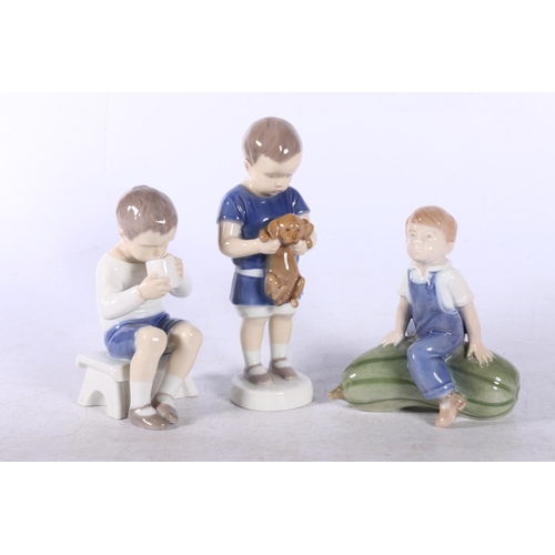 155 - Three Royal Copenhagen figures to include Boy on Cucumber #4539, Boy holding a Puppy #1747 and anoth... 