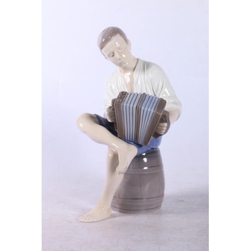 159 - Bing and Grondahl figure of a seated male accordion player #1661, 21cm tall.