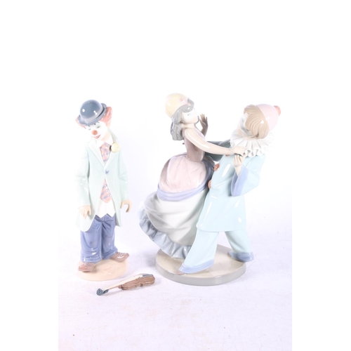 199 - Two Lladro figures to include Masquerade 5452 and Clown with violin 5472 (2).