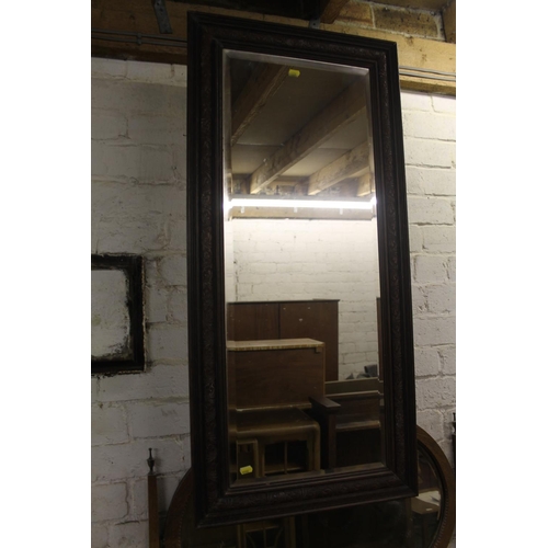 776 - Rectangular bevel-edge wall mirror in carved oak frame, 105cm.