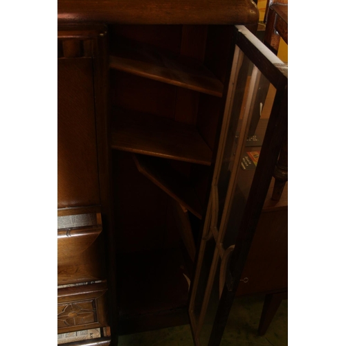 783 - Oak art deco style cabinet with central drawers flanked by twin astragal glazed doors, 121cm wide.