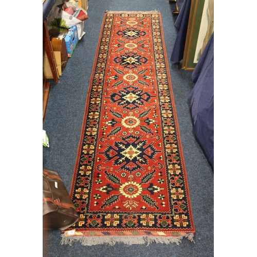 796 - Red ground Afghan runner, 320cm x 82cm.