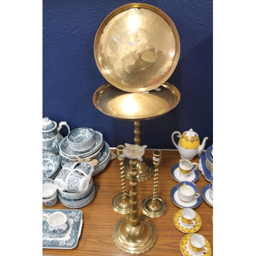 234 - Pair of eastern brass occasional tables and a pair of brass candlesticks,  (4).