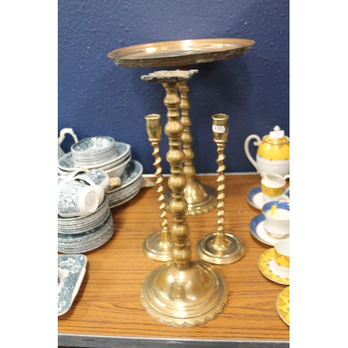 234 - Pair of eastern brass occasional tables and a pair of brass candlesticks,  (4).