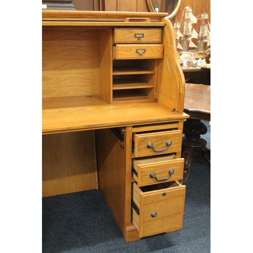 745 - Oak twin pedestal roll top desk with fitted interior, 138cm wide.