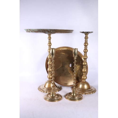 234 - Pair of eastern brass occasional tables and a pair of brass candlesticks,  (4).