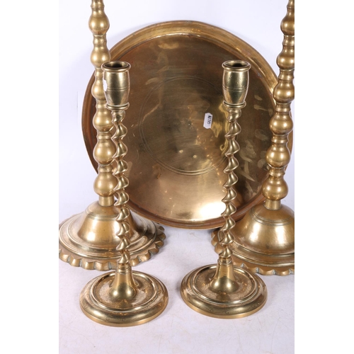 234 - Pair of eastern brass occasional tables and a pair of brass candlesticks,  (4).