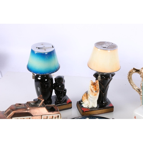 713 - Novelty cigarette lighters to include boat, dice, dog and cat lamp etc. 