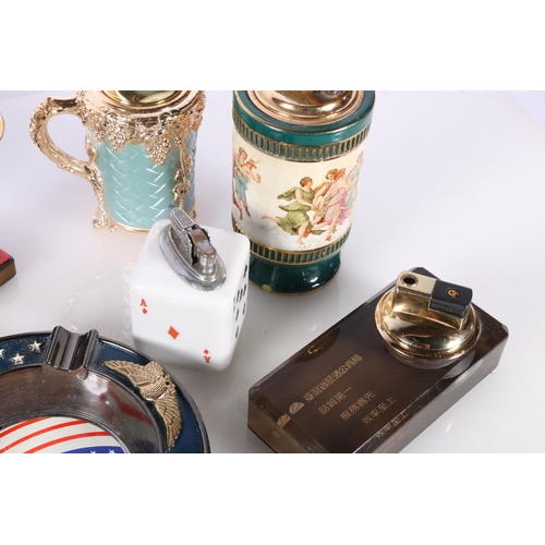 713 - Novelty cigarette lighters to include boat, dice, dog and cat lamp etc. 