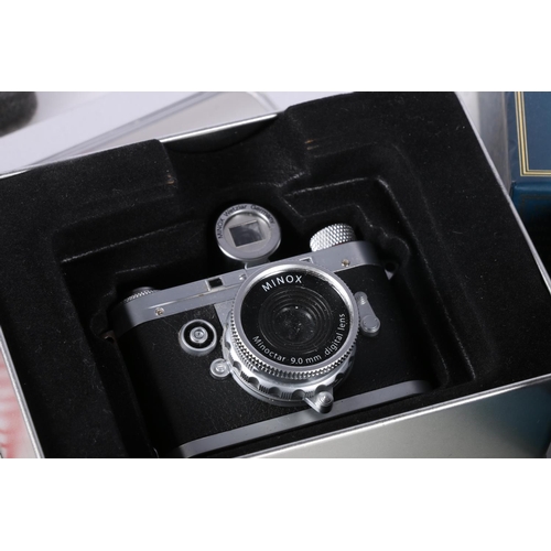 722 - Minox DCC 5.1 miniature digital camera boxed, a Detomaso digital wristwatch boxed, a Polaroid camera... 