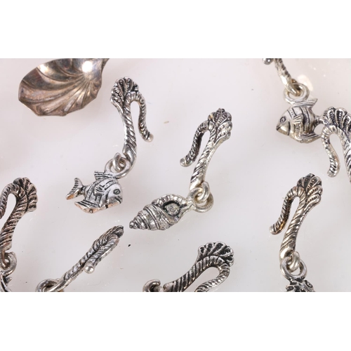 728 - White metal taste vin, three white metal napkin rings, group of white metal sea themed hook weights ... 