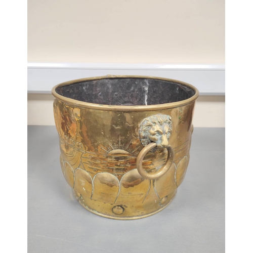 163 - 19th century brass jardiniere with lion mask ring handles, embossed decoration to the body above rou... 