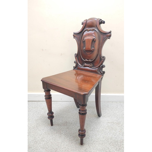 403 - Victorian mahogany hall chair with shaped scroll back bearing scroll cartouche to the centre, on spi... 