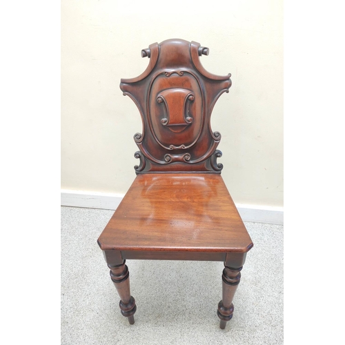 403 - Victorian mahogany hall chair with shaped scroll back bearing scroll cartouche to the centre, on spi... 