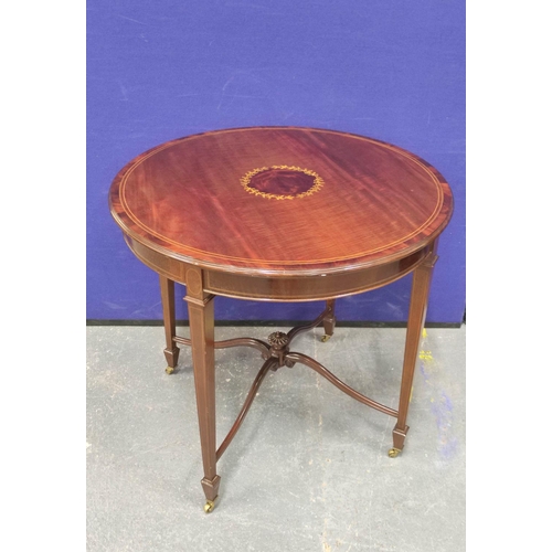 405 - Edwardian inlaid mahogany centre table, The circular top on tapered supports with brass castors with... 