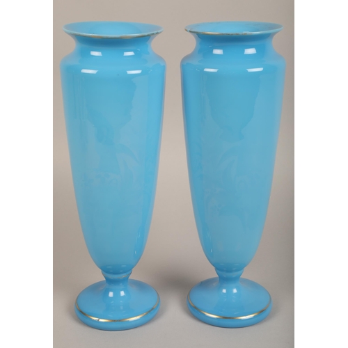 36 - Pair semi opaque blue glass vases with floral bird design and gilt detailing, 32 cm high