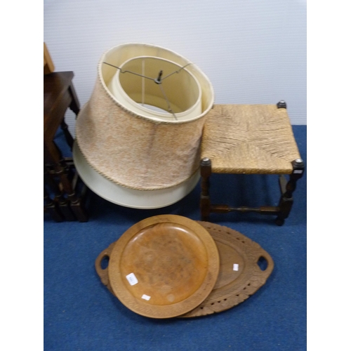 421 - Oak-framed stool, two wooden trays and a quantity of lampshades.