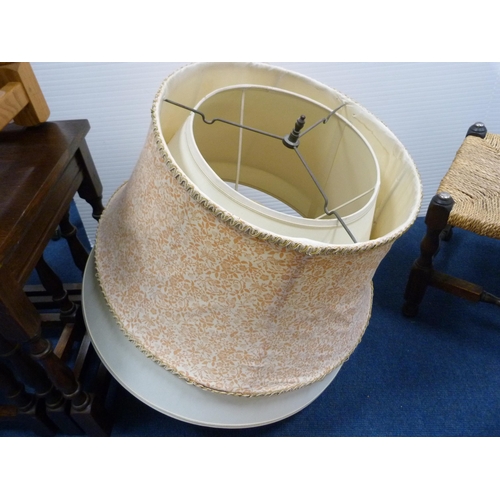 421 - Oak-framed stool, two wooden trays and a quantity of lampshades.