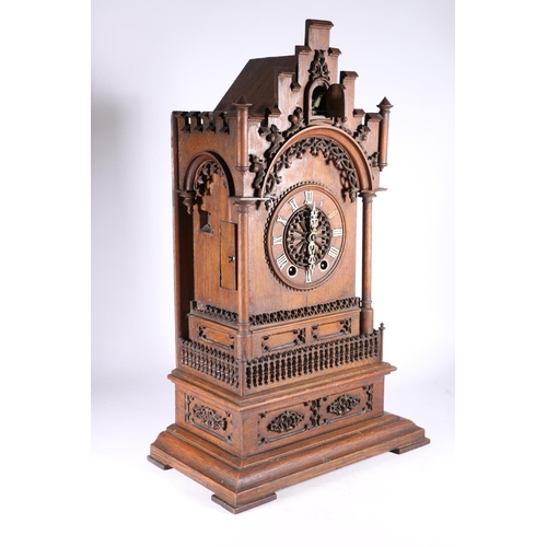 378 - German oak cuckoo clock in architectural castle shaped case, the movement striking on a gong, 67cm t... 