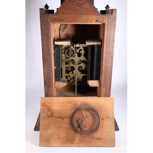 378 - German oak cuckoo clock in architectural castle shaped case, the movement striking on a gong, 67cm t... 