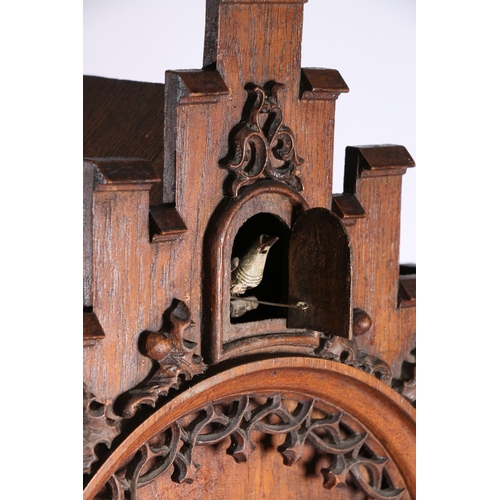 378 - German oak cuckoo clock in architectural castle shaped case, the movement striking on a gong, 67cm t... 