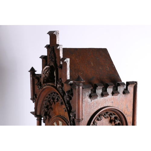 378 - German oak cuckoo clock in architectural castle shaped case, the movement striking on a gong, 67cm t... 