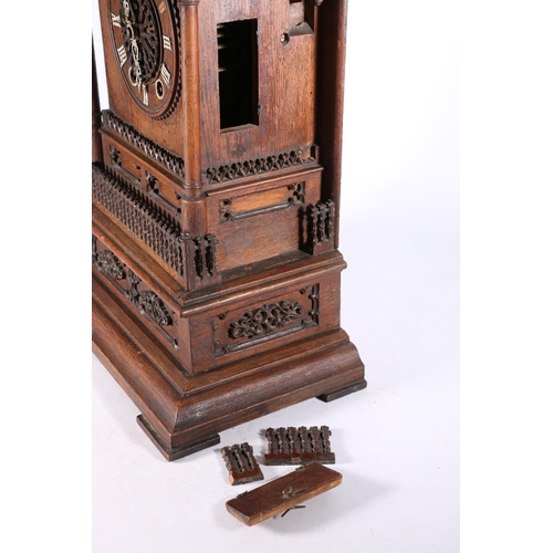 378 - German oak cuckoo clock in architectural castle shaped case, the movement striking on a gong, 67cm t... 